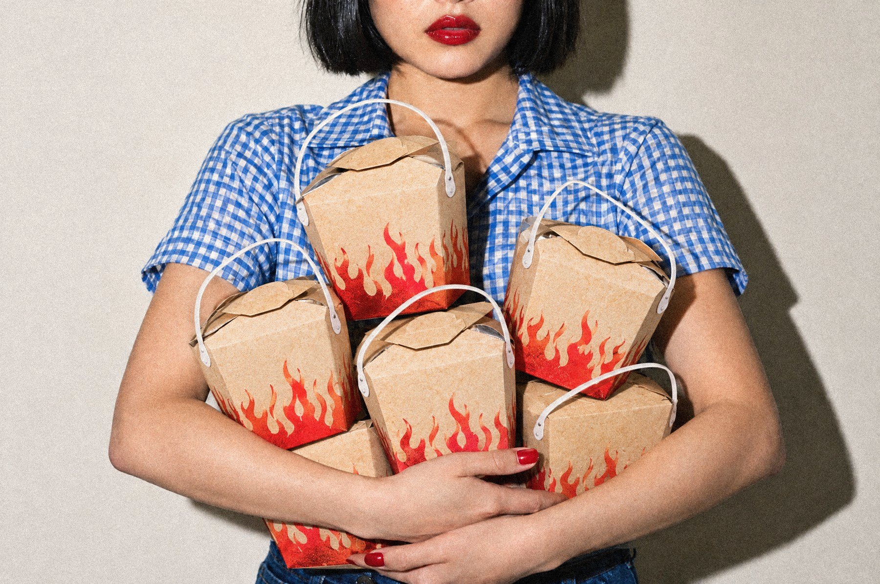 A guest hugging a stack of Soy N Lime carryout boxes